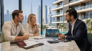 How to Buy Property in Dubai from UK – real estate agent advising a UK couple on purchasing property in Dubai with skyline view and documents on table