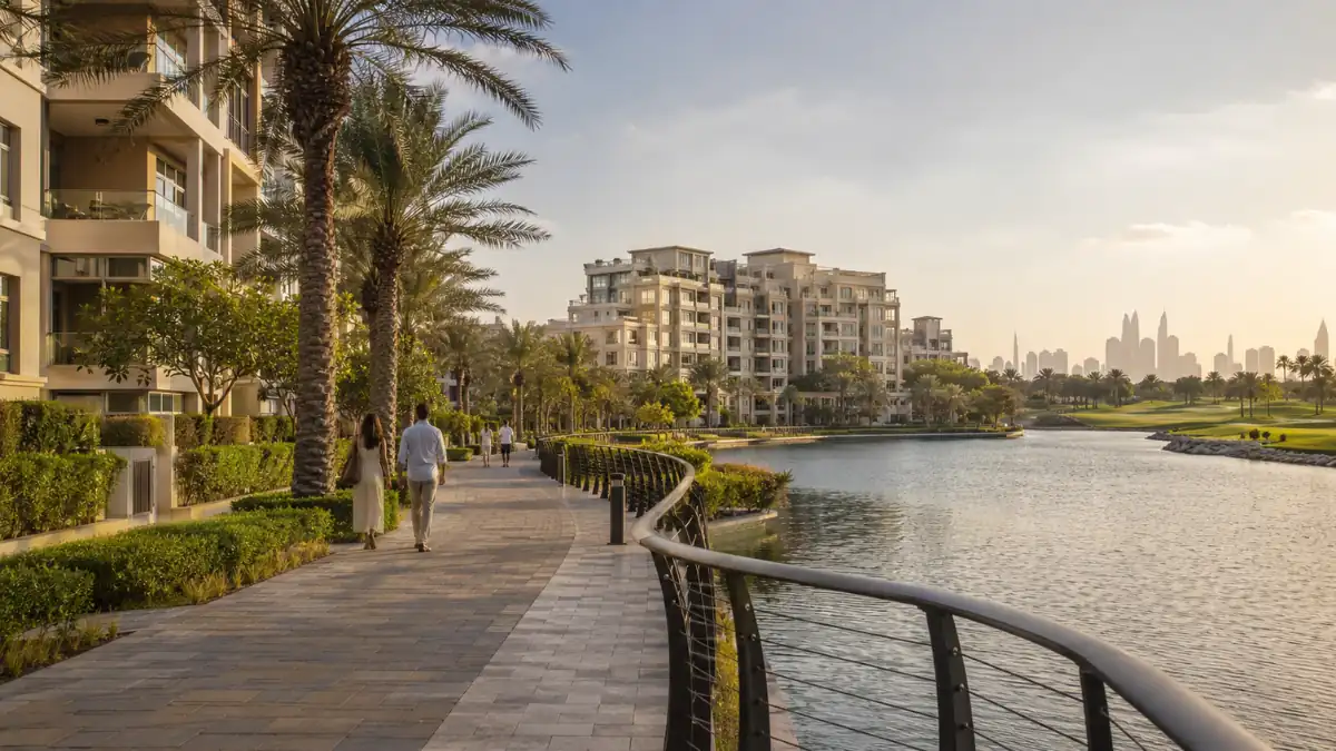 Scenic waterfront promenade at Dubai The Views featuring luxury residential apartments, palm trees, landscaped walkways, and skyline views in a premium Dubai community.